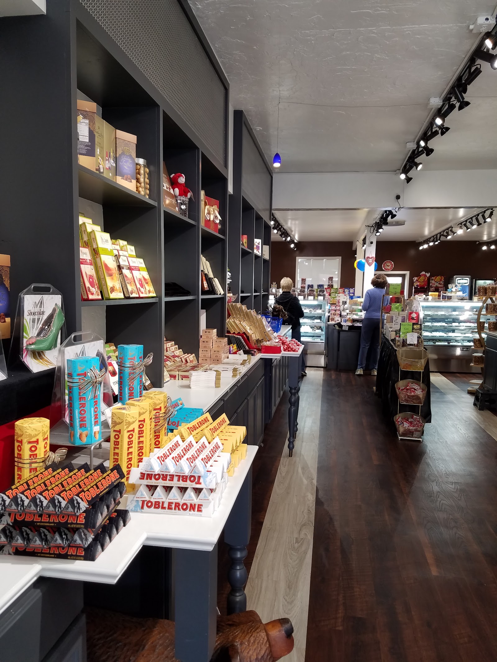 Boutique aisle with Toblerone merchandising and chocolate cases